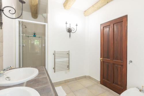 a bathroom with a sink and a toilet and a mirror at 4 Piet Retief in Stellenbosch