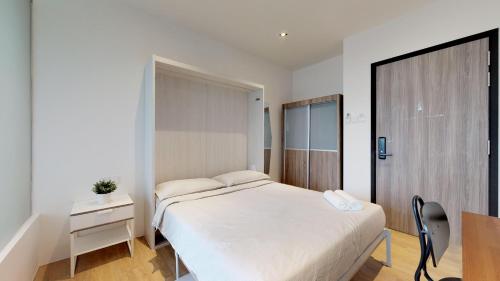 a bedroom with a bed and a table and a chair at International Service Apartments at Raeburn Park in Singapore