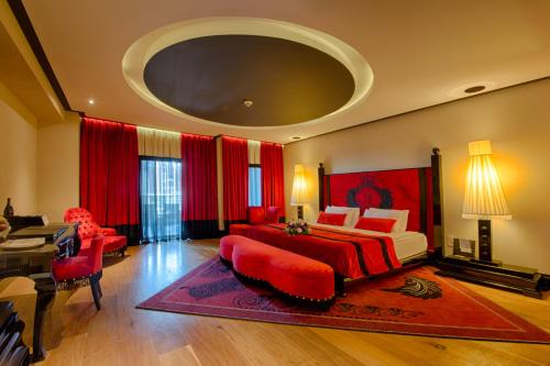 a large bedroom with a bed and a piano at Selectum Luxury Resort Belek in Belek