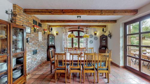 a dining room with a table and chairs at Osada Ulnowo - Holliday & Party House in Grunwald
