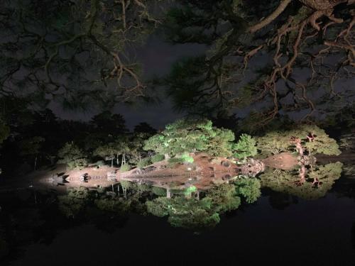 an island in the water at night at 777 Takamatsu Guest House in Takamatsu