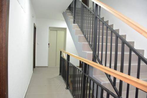 a staircase in a house with black railings at Cvetkovic LUX Аpartmani & Free GARAŽA in Vrnjačka Banja