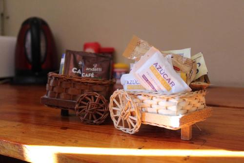 a table with two baskets of food and a wagon at Cancun Guest House 3 near Ado bus terminal and 25 min from-to airport by shuttle in Cancún