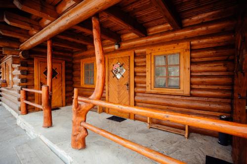 a log cabin with a bench in front of it at Jánošíkova Valaška Hills Apartments in Terchová