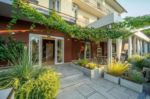 a house with a courtyard with plants at Hotel Abc in Cervia