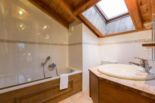 une salle de bain avec un lavabo et une baignoire dans l'établissement Apartment Capucin - A 3 Bedroom Chamonix Mountain Loft, à Chamonix-Mont-Blanc