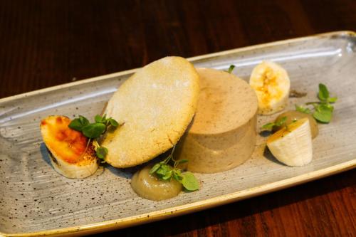 a plate of food with a sandwich and fruit at The Ambleside Inn - The Inn Collection Group in Ambleside