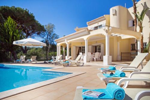 a villa with a swimming pool and a house at Villa Tulum by Algarve Vacation in Almancil