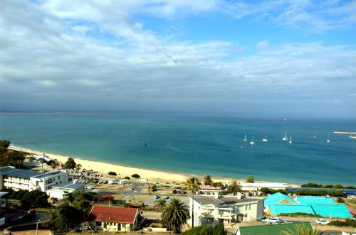 a view of a beach with boats in the water at view at the bay 4 in Mossel Bay