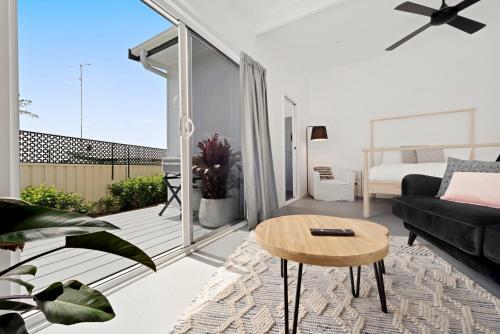 a living room with a couch and a table at Studio Ocean Breeze @ Huskisson in Huskisson