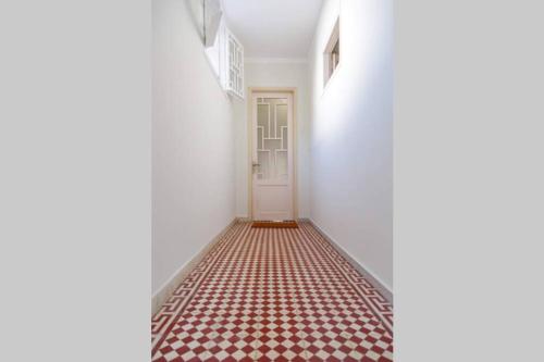 a hallway with a red and white tile floor at Home Sweet Home 1 in Nafplio