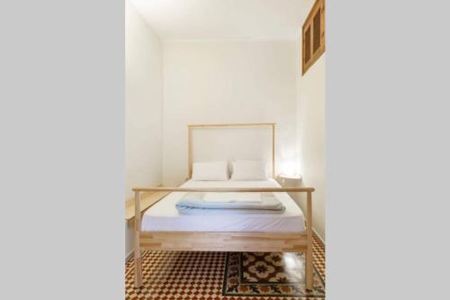 a small bedroom with a bed and a rug at Home Sweet Home 1 in Nafplio