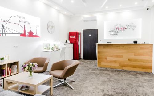 a room with two chairs and a table and a red refrigerator at 7Days B&B in Bratislava