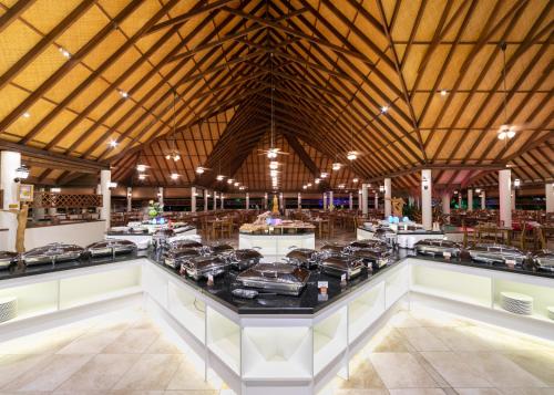 a large kitchen with a stove top in a building at Fihalhohi Maldives in South Male Atoll