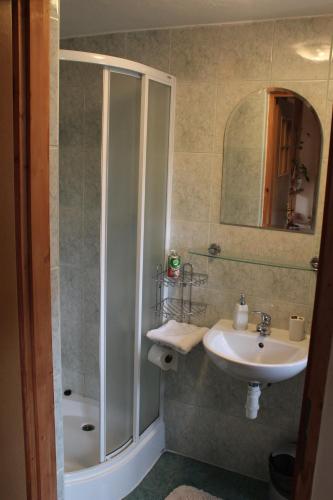 a bathroom with a shower and a sink at Marko Apartmány in Oščadnica