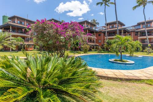 a resort with a swimming pool in front of a building at Cumbuco Dream Village Luxury Condo in Cumbuco