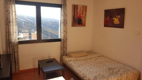 a small bedroom with a bed and a window at Nevada Home in Sierra Nevada