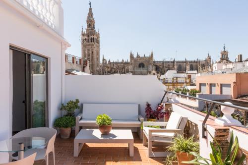 a balcony with a view of a building at Puerta Catedral Holiday Suites in Seville