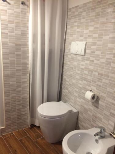 a bathroom with a toilet and a sink at La Pietra Gialla in Pietrapertosa