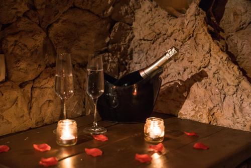 a bottle of champagne and two glasses on a table at B&B La Sorgente in Brindisi
