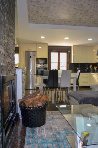 a kitchen and living room with a glass table at Casinha do Eido Novo - Alojamento Local in Valença