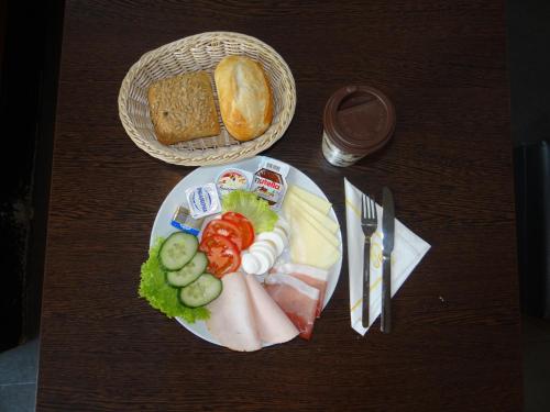 a plate of food with meat and cheese and bread at Apartment in Innenstadtnähe in Darmstadt