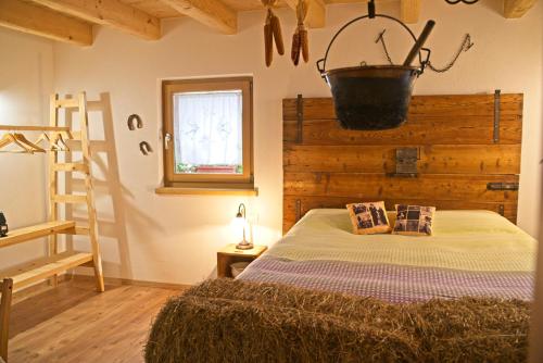 a bedroom with a bed with a bucket on the wall at B&B Ai Marchetini in Cinte Tesino