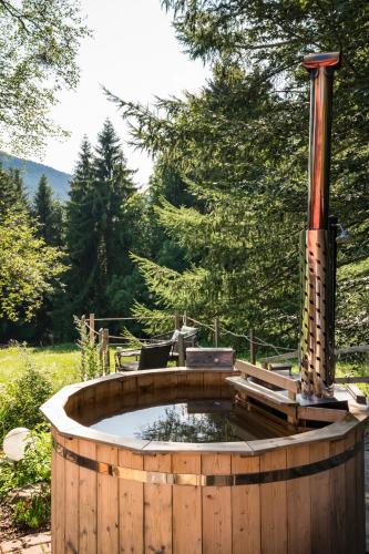 a wooden tub with a fountain in a garden at Jungholz Chalet 65 in Jungholz