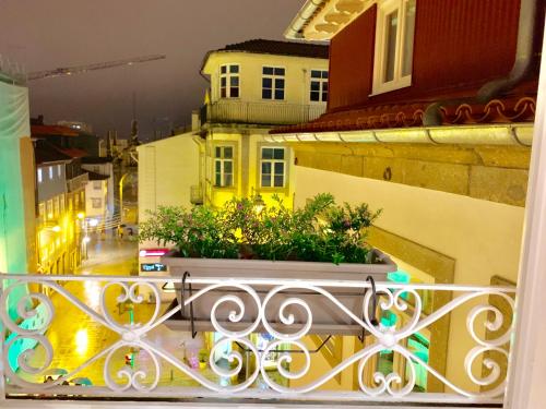 a balcony with a pot of plants on a building at The Arch - Charming Apartments in the Historic Center in Braga