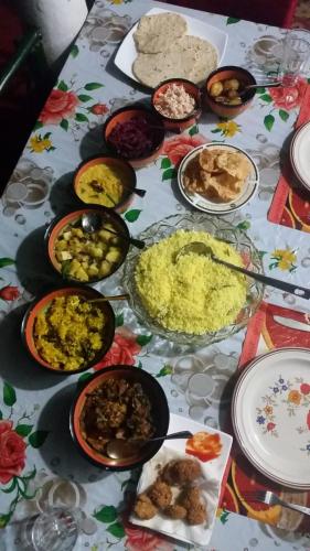 a table with many plates of food on it at Tunnel Gap Homestay in Ella
