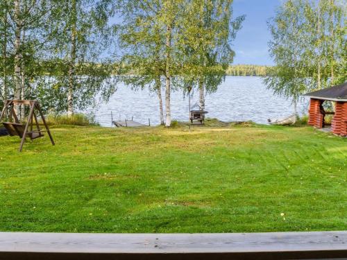 a view of a lake with a gazebo at Holiday Home Iltarauha by Interhome in Ruvaslahti