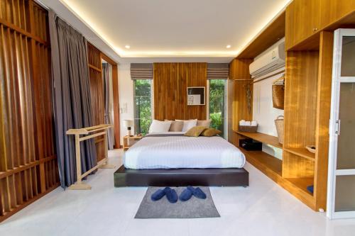 a bedroom with a bed and a large window at Ao Luek Panoramic Pool-SHA Plus in Ao Luk