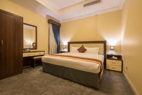 a hotel room with a bed and a mirror at Lahoya Hotel in Jeddah
