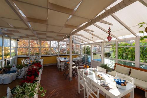 a restaurant with tables and chairs and windows at QuodLibet in Rome
