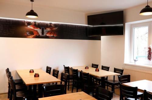 a dining room with wooden tables and chairs at Penzion&Pizzerie U Massima in Vyškov