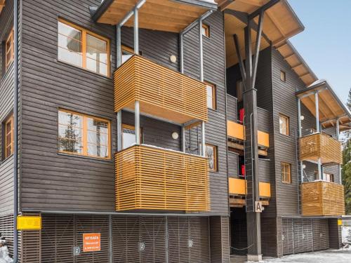 a building with wooden balconies on the side of it at Holiday Home Karhunvartijan linna a1 by Interhome in Ruka