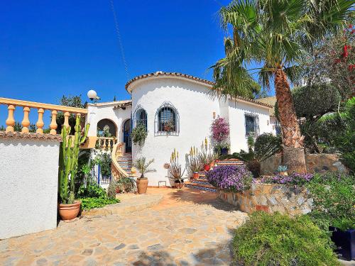 une maison blanche avec un palmier en face dans l'établissement Holiday Home Mirada al Sol by Interhome, à Moraira