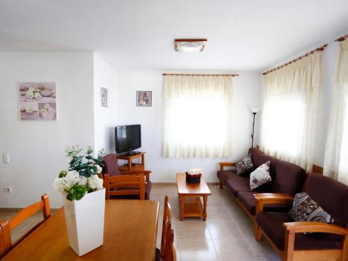a living room with a couch and a table at Holiday Home Vicky by Interhome in Riumar