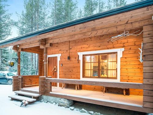 a log cabin in the snow with a window at Holiday Home Honkakeko by Interhome in Sirkka