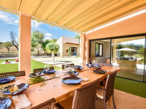 a dining room with a large wooden table and chairs at Holiday Home Son Tey by Interhome in Sineu