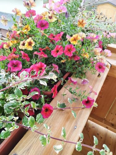 a bunch of flowers on a wooden table at Marie Luise, Landhaus in Reith bei Kitzbühel