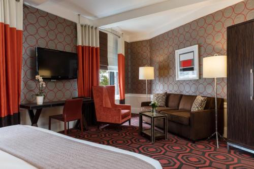 a hotel room with a bed and a couch at The Empire Hotel New York in New York