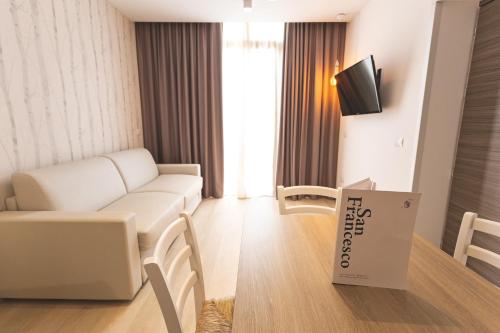 a living room with a white couch and a tv at Antico Podere San Francesco in Vada