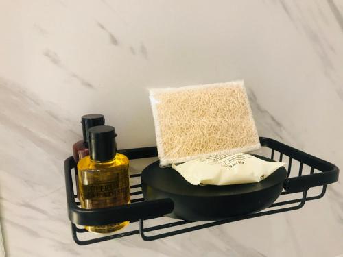 a black shelf with a bottle of perfume and a towel at Cassa Luxury Homes in Bogotá