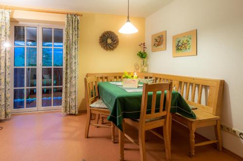 a dining room with a table and chairs and a window at Ferienwohnungen Hotel Garni Dörflerwirt in Aflenz Kurort