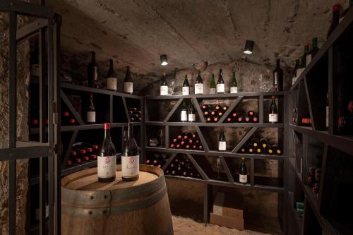 a wine cellar with bottles of wine on a barrel at Castel Hörtenberg in Bolzano