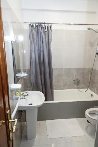 a bathroom with a sink and a shower and a toilet at lisbon Home host in Lisbon