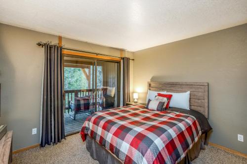 a bedroom with a bed and a balcony at Hidden Haven Condominium in Shaver Lake