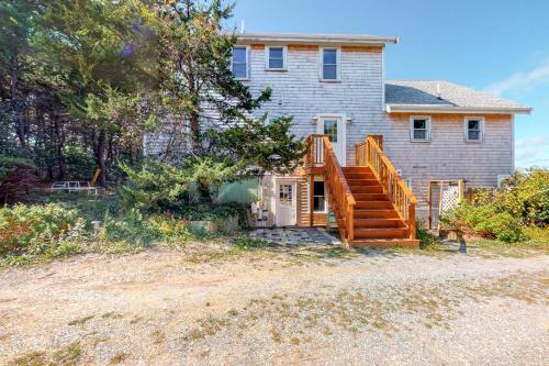 a house with a wooden staircase in front of it at Bayview in Truro