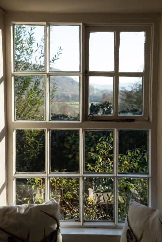 a window with a view of a mountain view at Witherslack Hall Farmhouse in Grange Over Sands